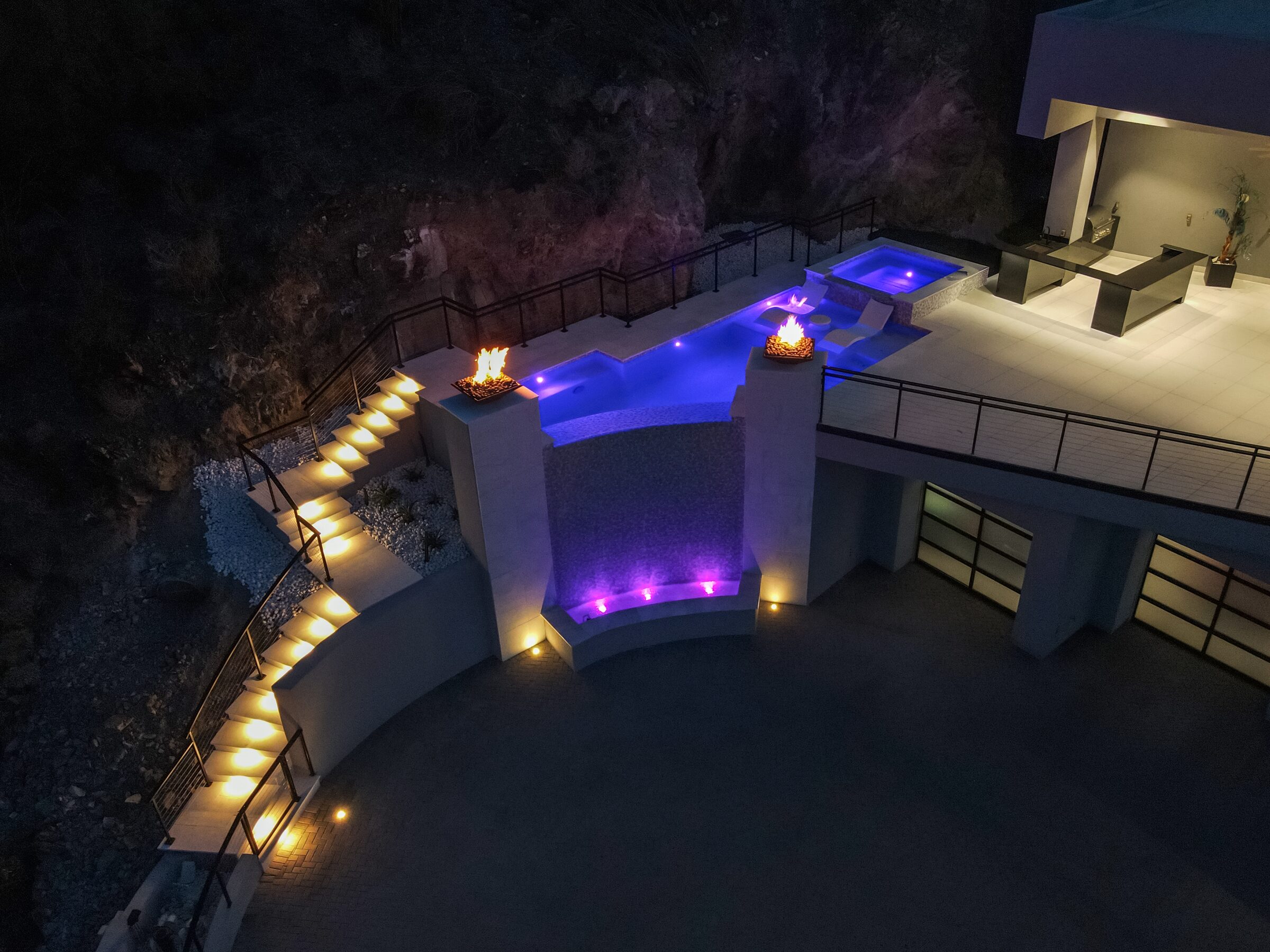 Luxury pool with mountain views at night